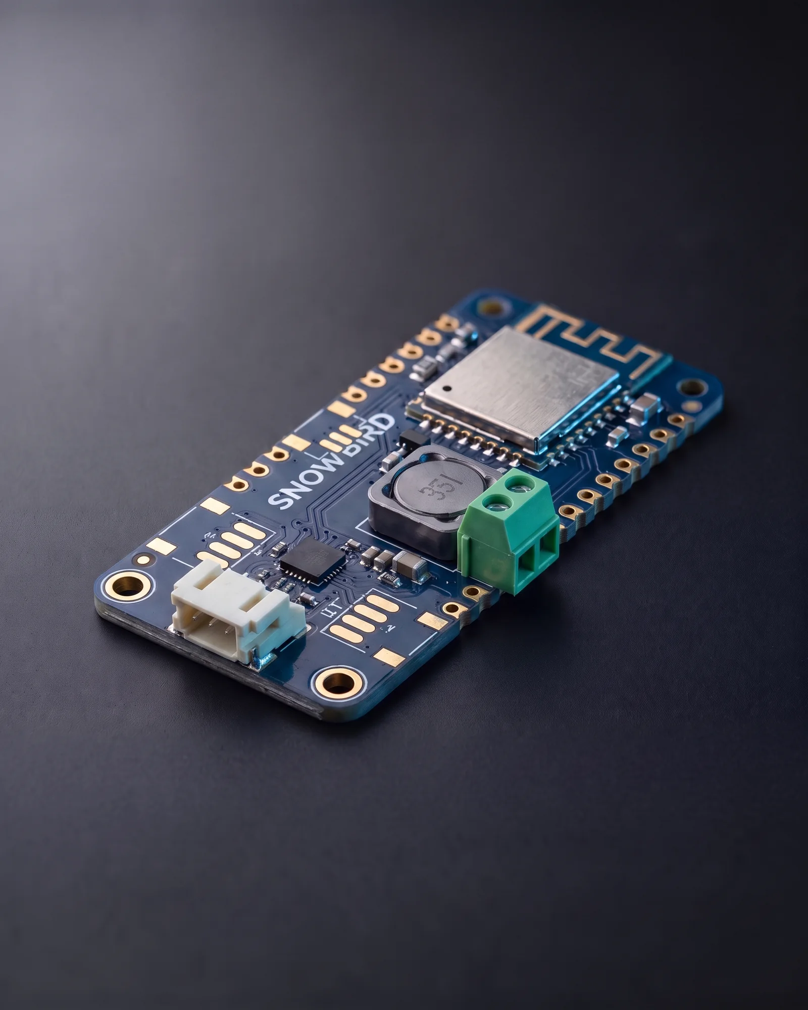 The Snowbird Core 1S: the Feather 1S board with the USB-C, Qwiic and solar connectors left off, their gold pads exposed, ready to solder onto a carrier.